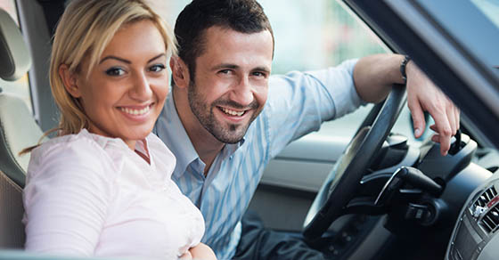 Smiling,,Couple,Posing,Sitting,In,A,Car